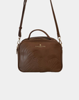 Oceans End Justine 2.0 crossbody bag in mocha featuring an embossed hibiscus design, top handle, adjustable crossbody strap, and gold-tone hardware.