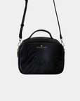 Oceans End Justine 2.0 crossbody bag in onyx featuring an embossed hibiscus design, top handle, adjustable crossbody strap, and gold-tone hardware.