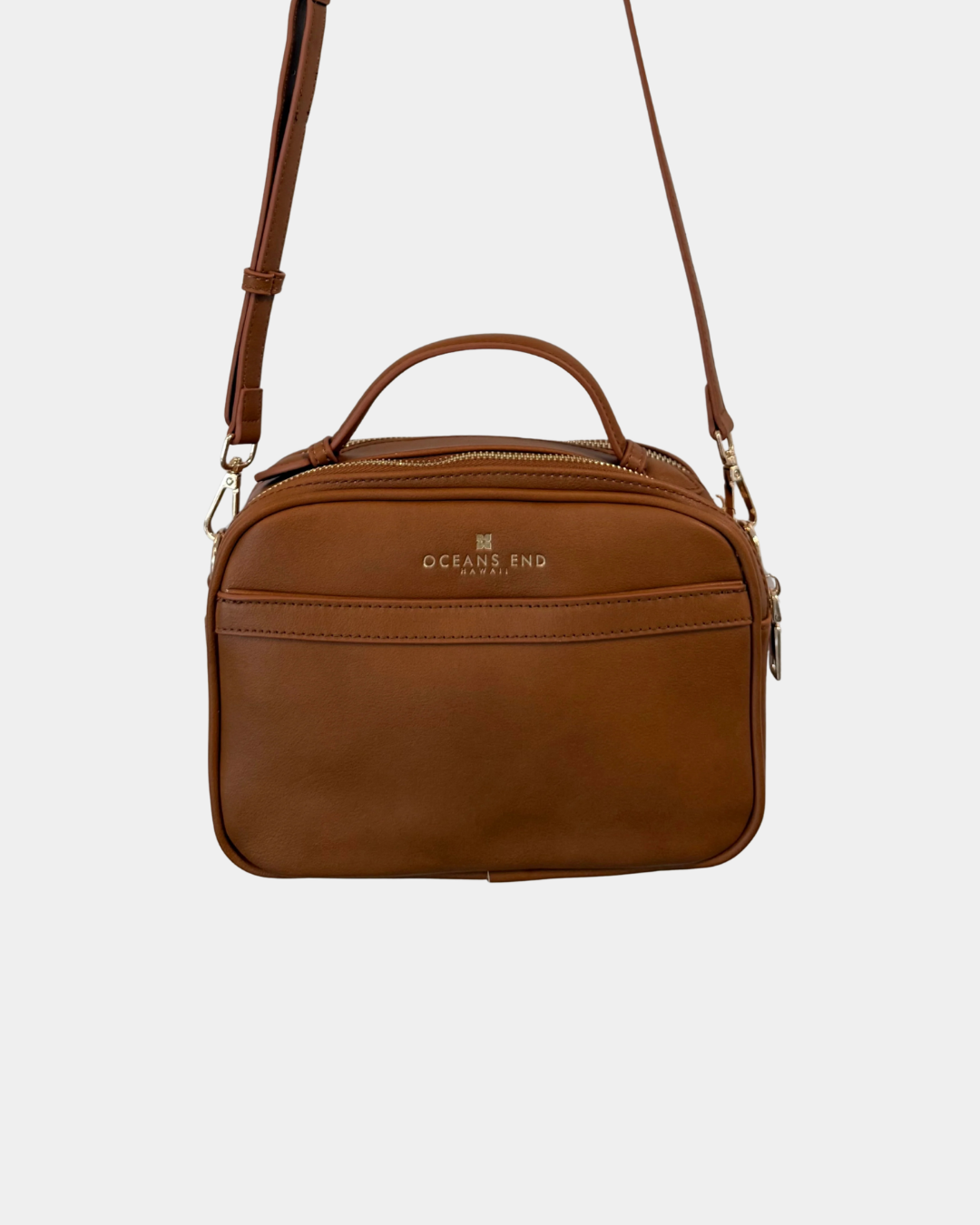 Back view of the Oceans End Justine 2.0 saddle crossbody bag featuring a convenient exterior slip pocket, top handle, and adjustable shoulder strap.