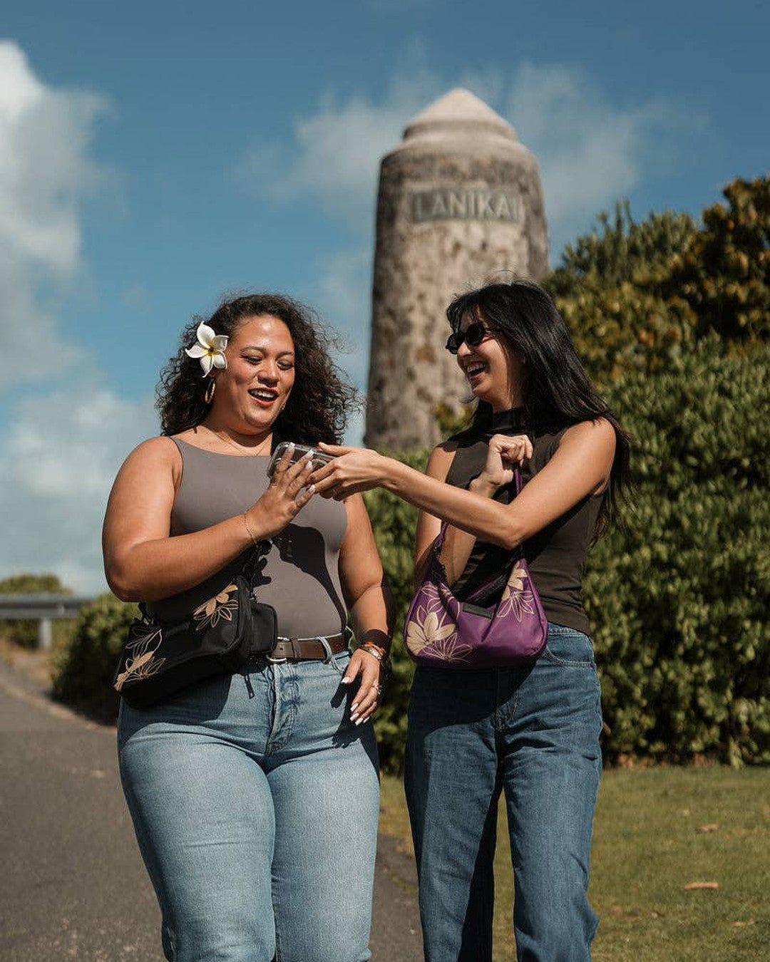 Two women walking outdoors with Oceans End Kamalani bags in black and purple