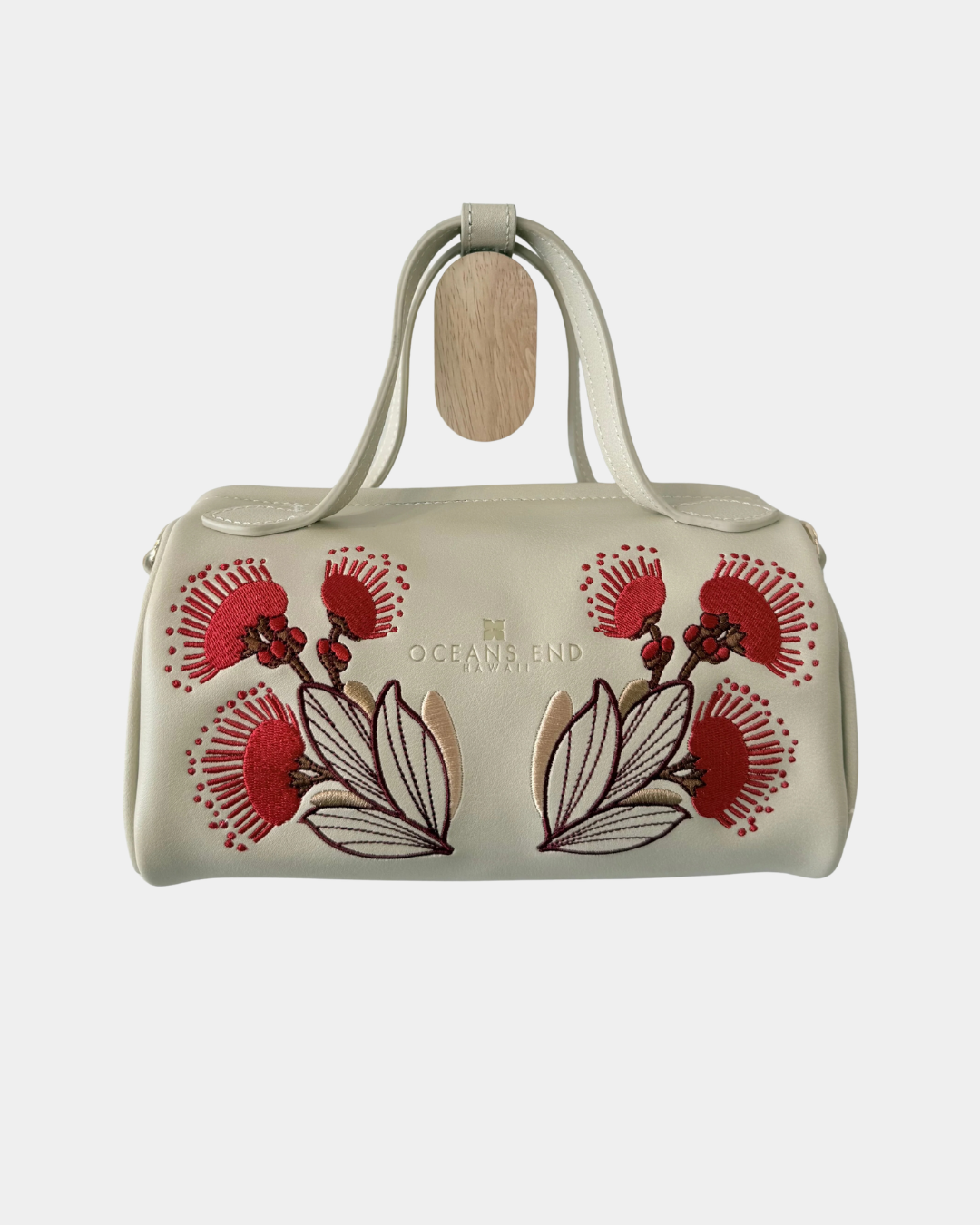Oceans End Lehua convertible handbag in creme vegan leather with embroidered lehua flowers and top handles