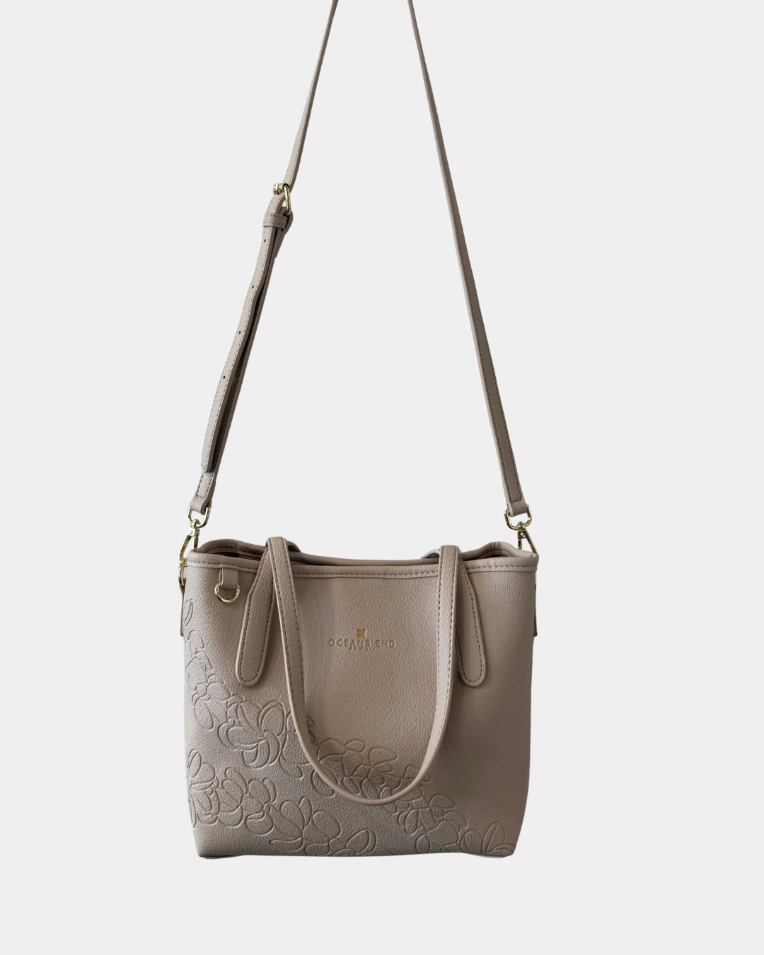 Oceans End Shawna convertible tote bag in bone worn as crossbody with adjustable strap