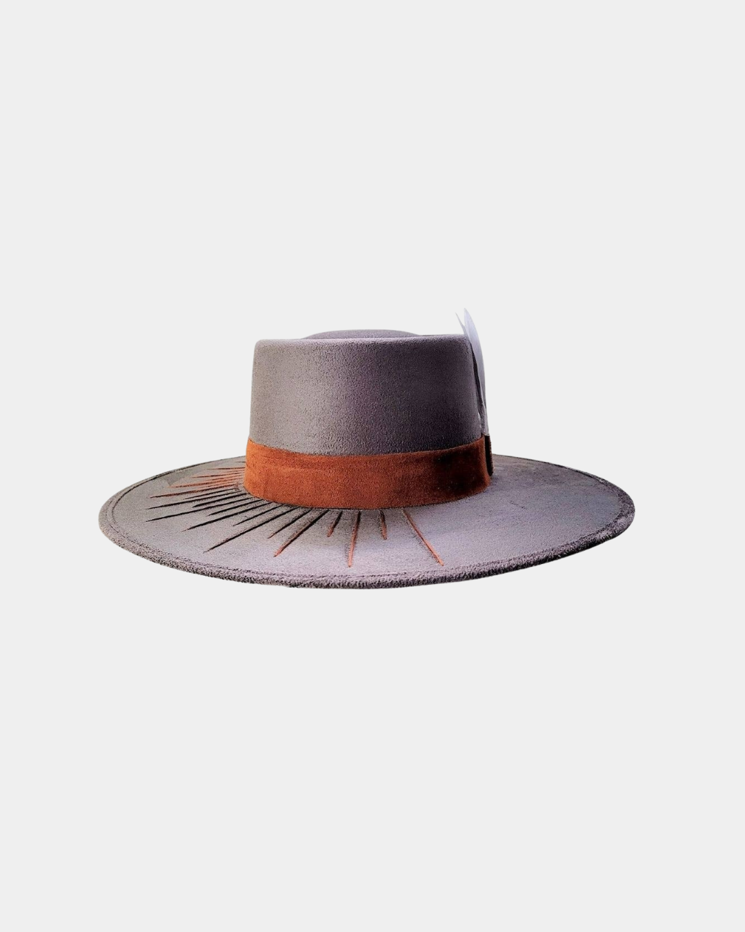 Close-up of the embroidered detailing and feather accent on the Camaleon hat.