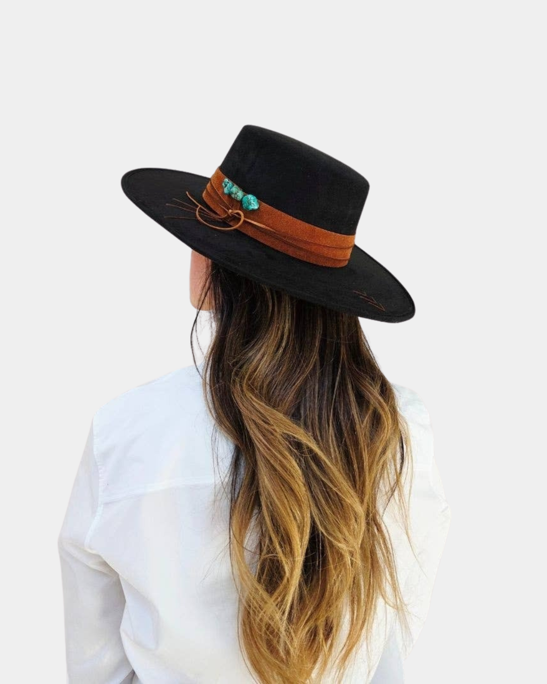 The Petra Savage Tasha Boater Crown Hat in black styled on a model for a chic, modern fashion look.