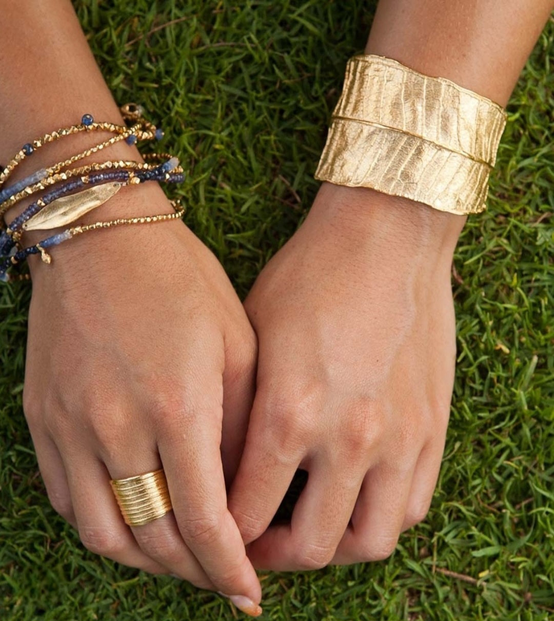 Handcrafted plumeria cuff bracelet inspired by Hawaiian flower motifs on model