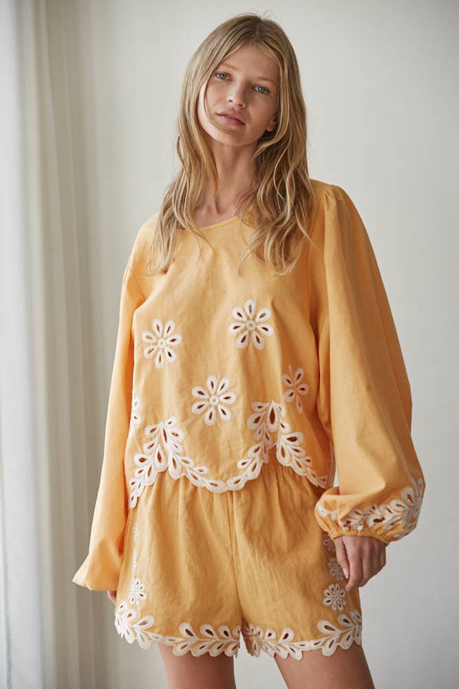 Resort embroidered puff sleeve top front view with detailed embroidery and relaxed fit
