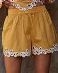 Close-up of resort embroidered shorts showing intricate embroidery and fabric detail