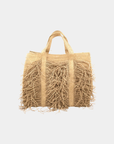 Sahara fringe raffia tote bag in natural color featuring woven texture and oversized silhouette on a neutral background.