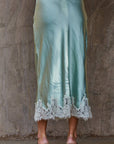 Back view of Silk Drift Skirt highlighting smooth satin fabric and clean, flowing silhouette