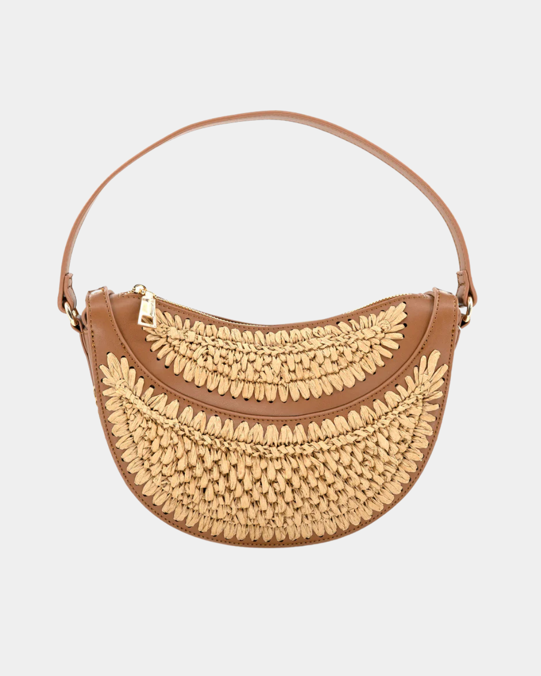 Close-up of handwoven raffia texture and leather trim on the Solstice half moon convertible bag.