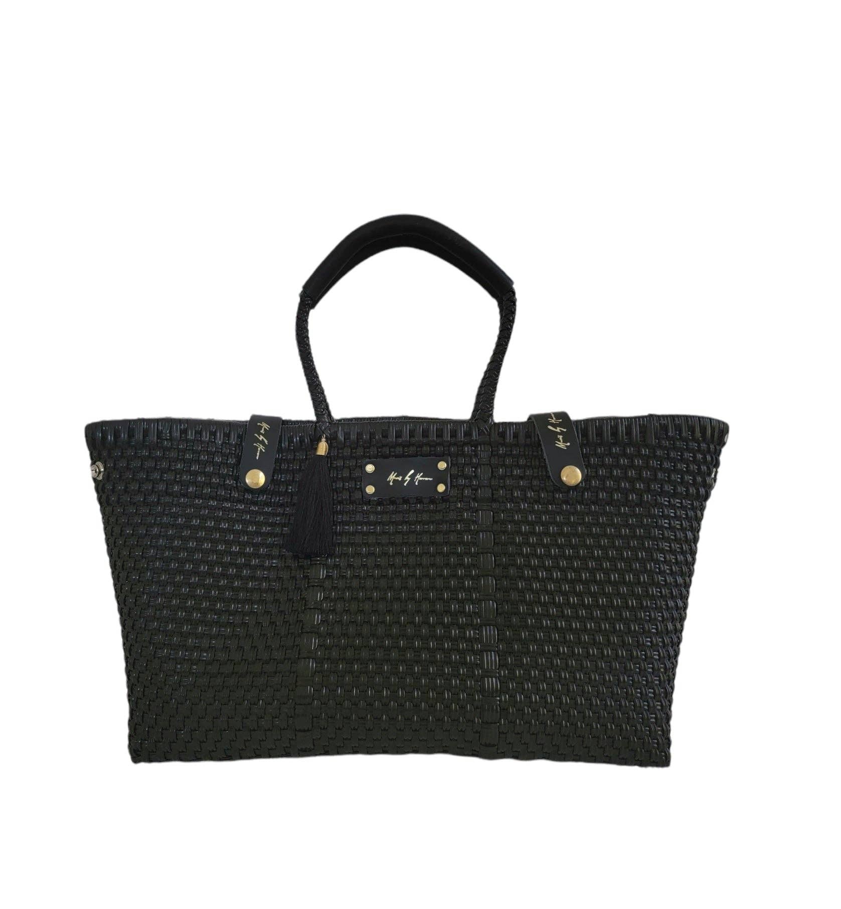 Sustainable luxury black handbag designed to fit a 16 inch laptop