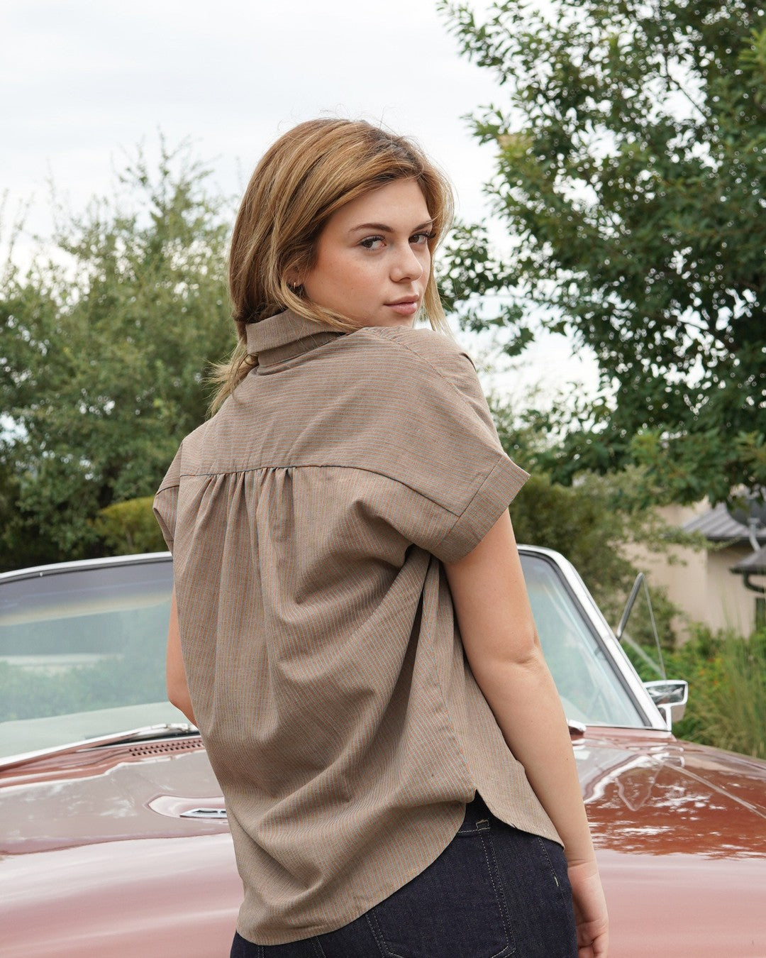 Back view of the Pin Stripe Button Down showing the pleated back yoke and relaxed fit